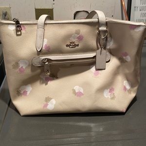 Coach floral hand bag. 10 1/2x15. Some wear on bottom.